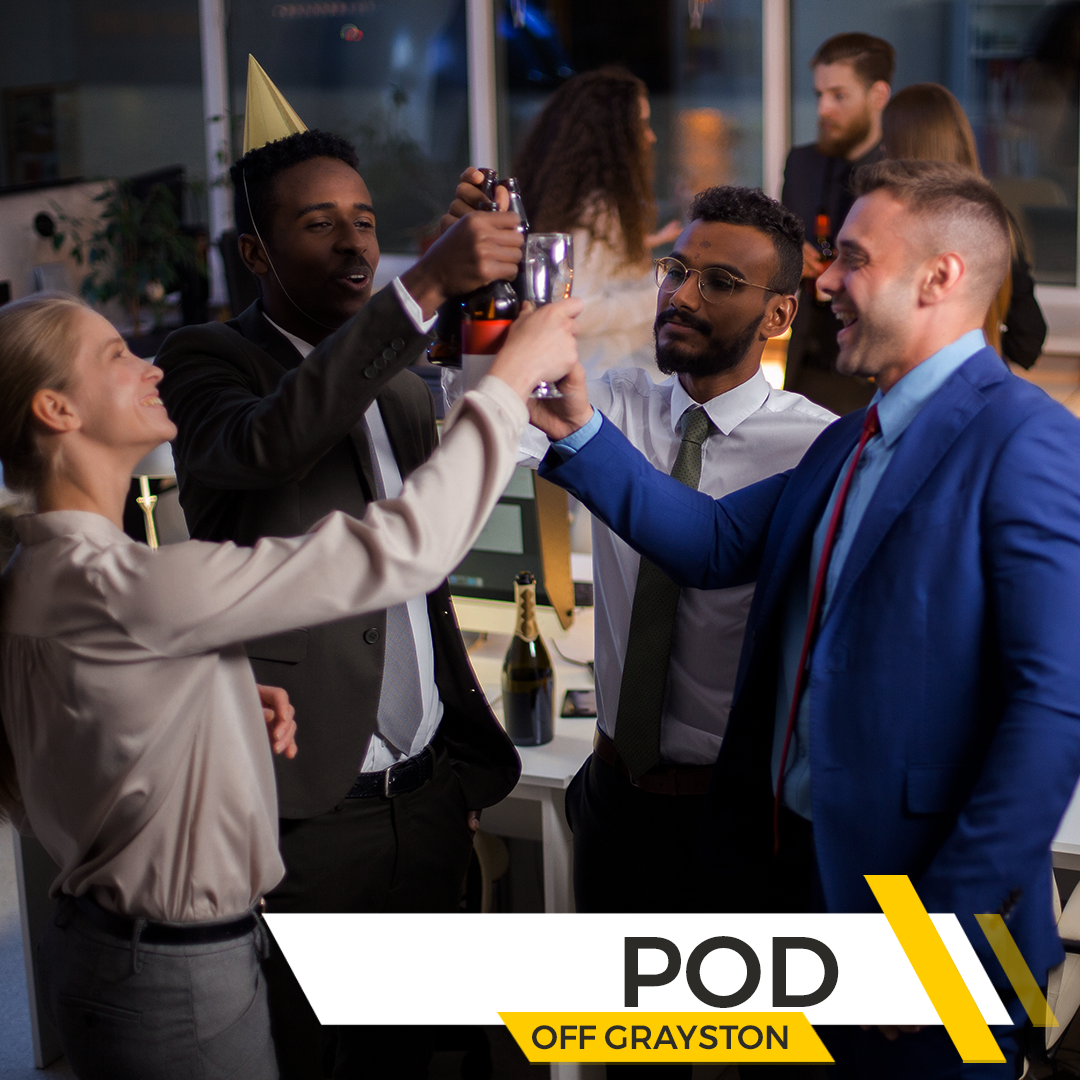 Group of professionals celebrating with drinks in an office setting, with the branding for The POD Off Grayston.